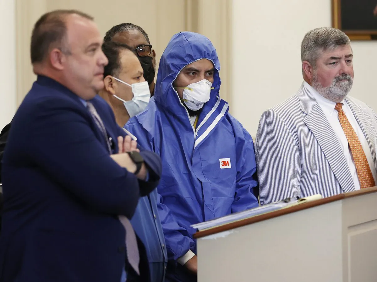 Julio Cesar Alvarado-Dubon (2nd L) and Rolman Balcarcel-Bavagas (2nd R), both charged with felony possession of a firearm by an illegal alien, stand with defense attorneys Jose Aponte (L) and Samuel Simpson V during a preliminary hearing before Judge David M. Hicks in Richmond City General District Court in Richmond, Va., on Aug. 3, 2022. (Alexa Welch Edlund/Richmond Times-Dispatch via AP)