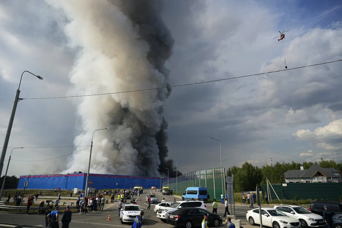 Smoke rises over a burning warehouse of the online retailer Ozon in Istra Municipal District, northwest Moscow Region, on Aug. 3, 2022. (Alexander Zemlianichenko/AP Photo)