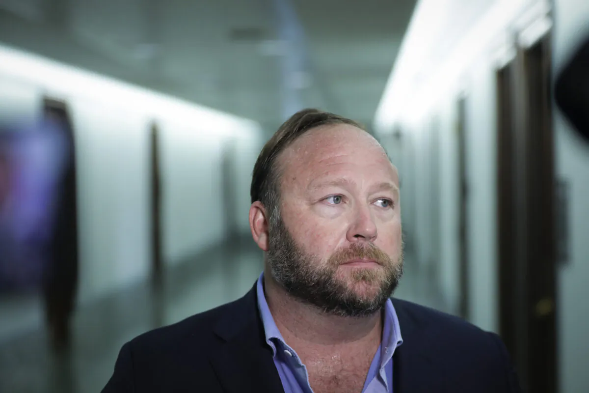 Alex Jones of InfoWars talks to reporters in Washington in a file image. (Drew Angerer/Getty Images)