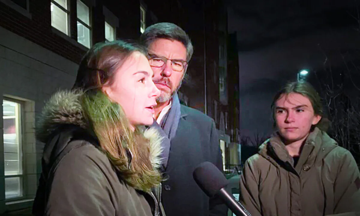 Clint Thomas, his wife, and one of his daughters speak to reporters outside the Loudoun County Public Schools administration building in Ashburn, Va., on Jan. 25, 2022. (Terri Wu/The Epoch Times)