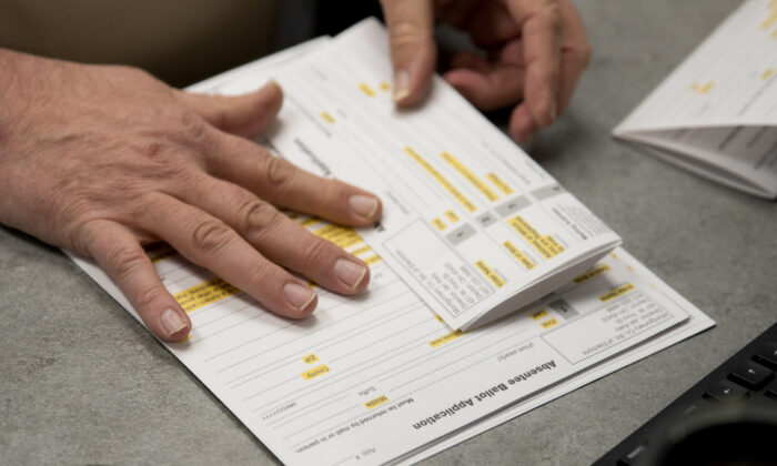 A county election worker prepares absentee ballots in Dayton, Ohio, on March 17, 2020. (MEGAN JELINGER/AFP via Getty Images)