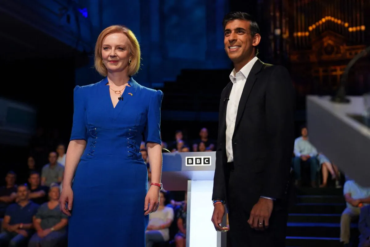 Britain's Foreign Secretary Liz Truss (L) and former Chancellor to the Exchequer Rishi Sunak, contenders to become the country's next prime minister, arrive to take part in the BBC's 'The UK's Next Prime Minister: The Debate' in Victoria Hall in Stoke-on-Trent, central England, on July 25, 2022. (Jacob King/POOL/AFP via Getty Images)