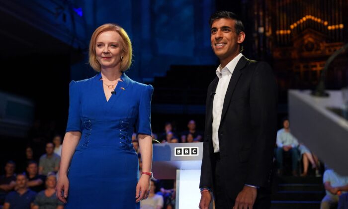 Britain's Foreign Secretary Liz Truss (L) and former Chancellor to the Exchequer Rishi Sunak, contenders to become the country's next prime minister, arrive to take part in the BBC's 'The UK's Next Prime Minister: The Debate' in Victoria Hall in Stoke-on-Trent, central England, on July 25, 2022. (Jacob King/POOL/AFP via Getty Images)