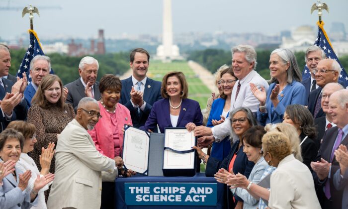 House Speaker Nancy Pelosi, alongside House Democrats, holds the CHIPS for America Act, providing domestic semiconductor manufacturers with billions in subsidies to cut reliance on foreign sourcing, after signing it during an enrollment ceremony outside the U.S. Capitol in Washington on July 29, 2022. (Saul Loeb/AFP via Getty Images)