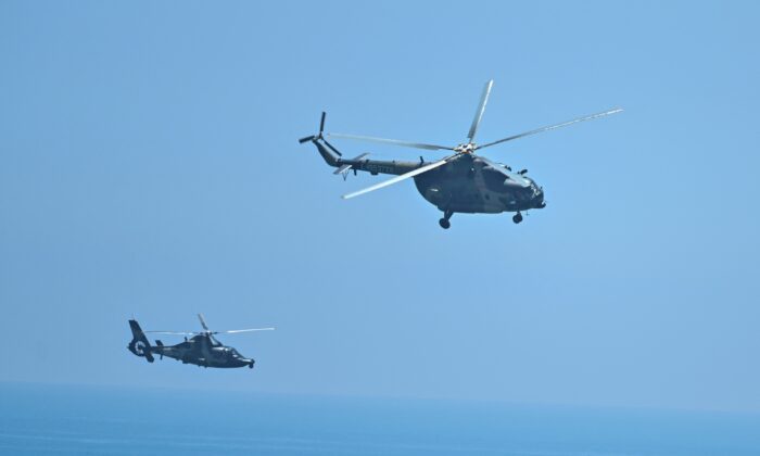 Chinese military helicopters fly past Pingtan island, one of mainland China's closest point from Taiwan, in Fujian province, ahead of military drills off Taiwan, on Aug. 4, 2022. (Hector Retamal/AFP via Getty Images)