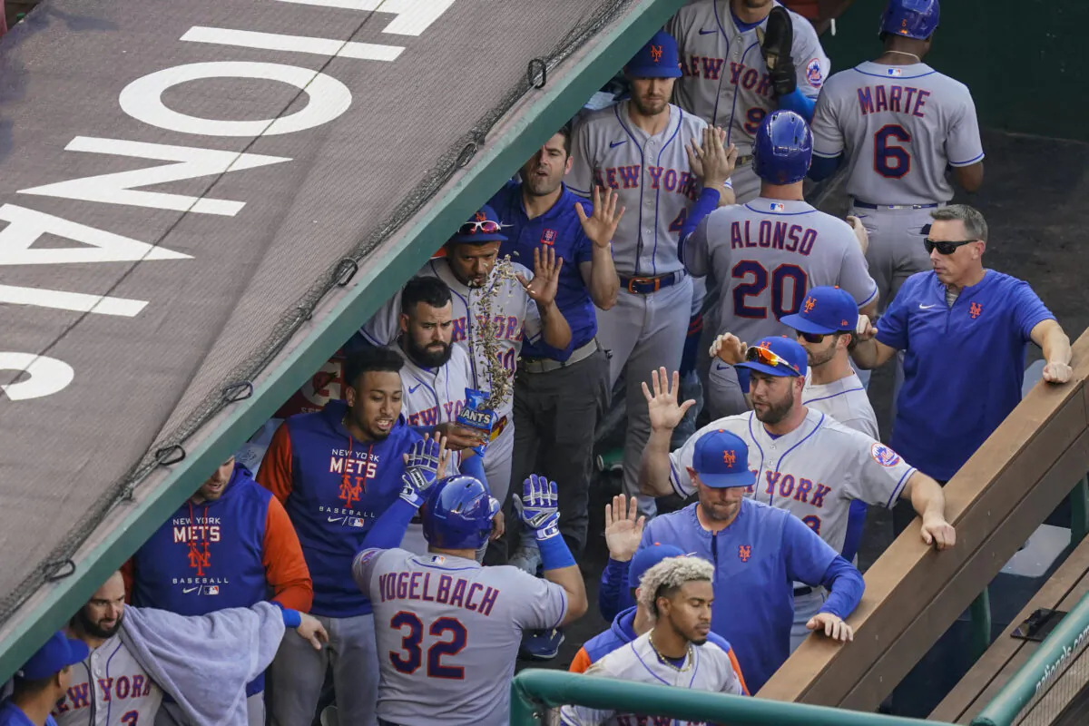 New York Mets' Daniel Vogelbach (32) is congratulated for his grand slam during the fifth inning of the team's baseball game against the Washington Nationals at Nationals Park, in Washington, Aug. 3, 2022. (Alex Brandon/AP Photo)