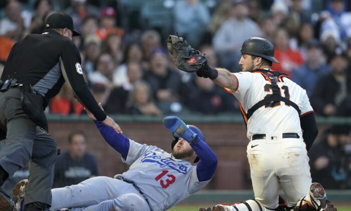 Los Angeles Dodgers' Max Muncy (13) scores past San Francisco Giants catcher Joey Bart (21) as umpire Cory Blaser watches during the fourth inning of a baseball game in San Francisco, Wednesday, Aug. 3, 2022. (AP Photo/Jeff Chiu)