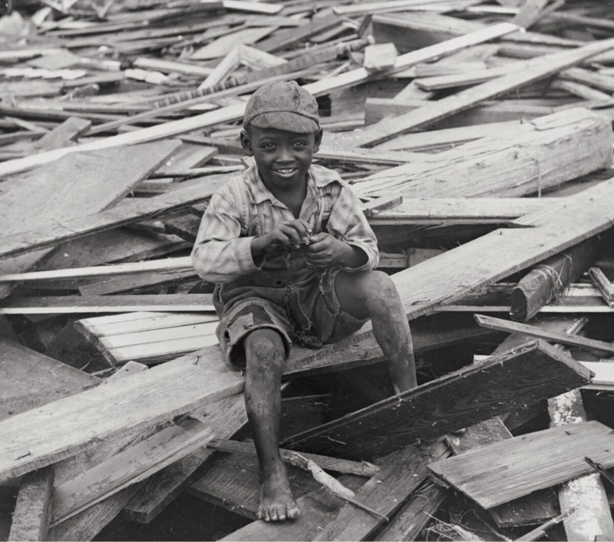 A young boy sits on debris in
the wake of the deadliest natural disaster in American history. (Zahner/Library of Congress)