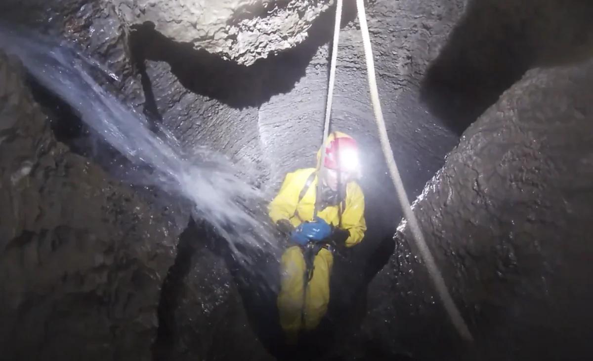 Caver Ciara Smart manages challenging conditions underground due to high water levels during descent in the Delta Variant cave system in Tasmania, Australia, 2022 on an unconfirmed date. (Image supplied by Ben Armstrong/Screenshot)