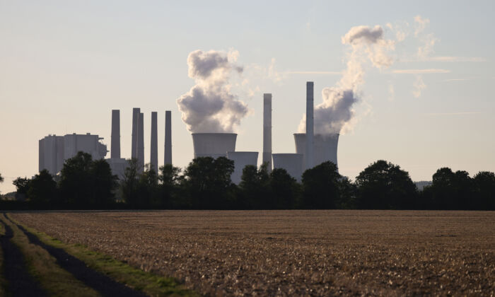 Steam rises from cooling towers of the Neurath coal-fired power plants, near Neurath, Germany, on Aug. 2, 2022. (Andreas Rentz/Getty Images)
