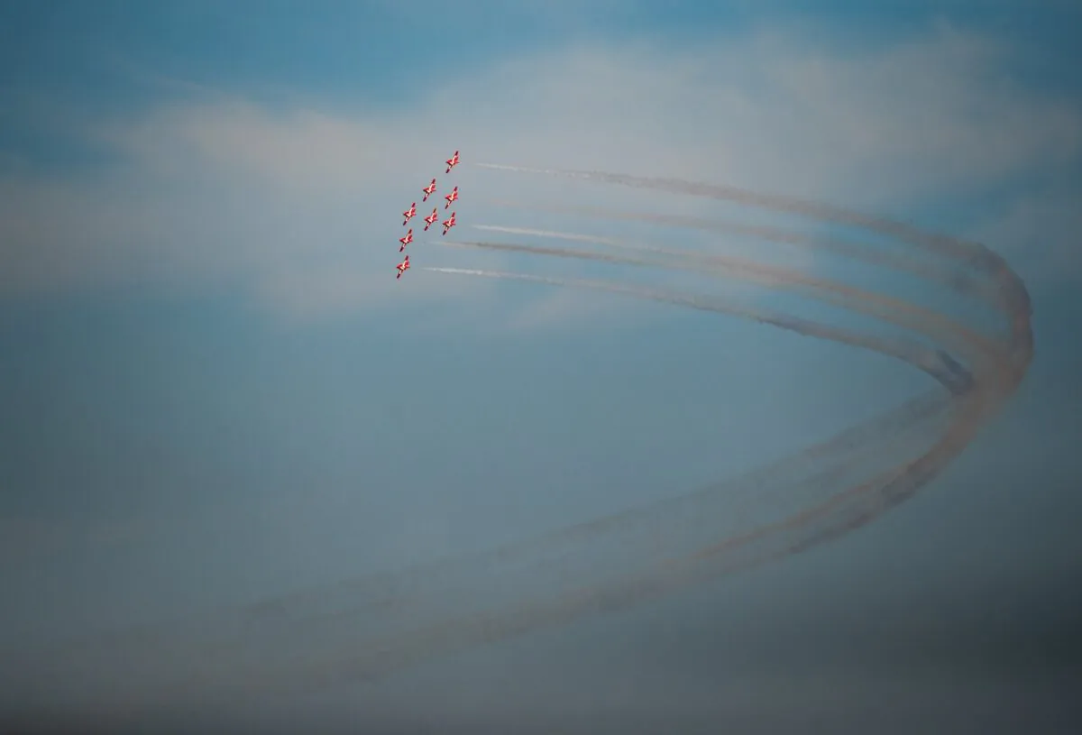 The Canadian Forces Snowbirds air demonstration team fly over English Bay as part of the Celebration of Light fireworks festival, in Vancouver, on July 27, 2022. (The Canadian Press/Darryl Dyck)