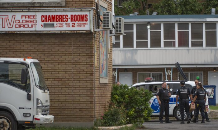 A 26-year-old man is dead after being shot by police in the parking lot of a motel in Montreal's Saint-Laurent borough early Aug. 4, 2022. (The Canadian Press/Peter McCabe)
