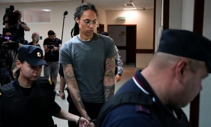 WNBA star and two-time Olympic gold medalist Brittney Griner (C) is escorted in a court room prior to a hearing, in Khimki just outside Moscow, Russia, on Aug. 4, 2022. (Alexander Zemlianichenko/AP Photo)