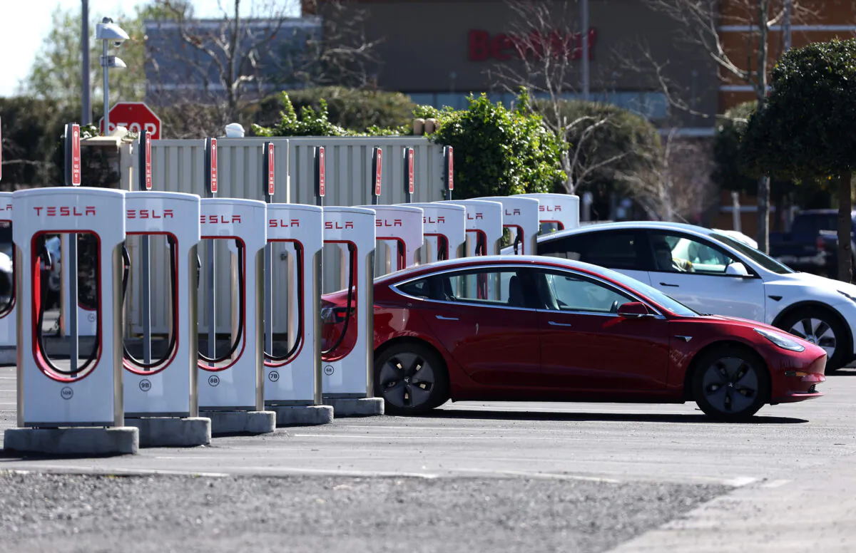 A Tesla car recharges its battery at the Petaluma Supercharger in Petaluma, Calif., on March 9, 2022. (Justin Sullivan/Getty Images/TNS)