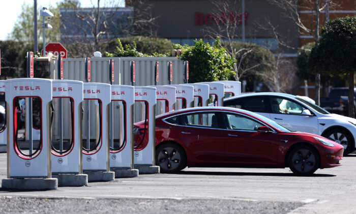 A Tesla car recharges its battery at the Petaluma Supercharger in Petaluma, Calif., on March 9, 2022. (Justin Sullivan/Getty Images/TNS)
