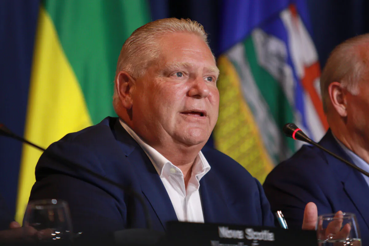 Premier Doug Ford responds to a question from the media at the Fairmont Empress in Victoria, B.C., on July 12, 2022. (The Canadian Press/Chad Hipolito)