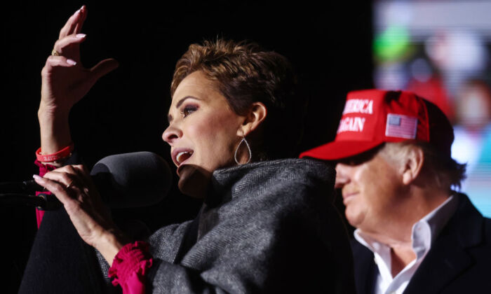 Republican gubernatorial nominee for Arizona Kari Lake (L) speaks as former President Donald Trump looks on at a rally at the Canyon Moon Ranch festival grounds in Florence, Ariz., on Jan. 15, 2022. (Mario Tama/Getty Images)
