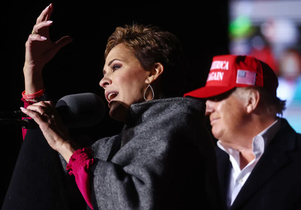 Republican gubernatorial candidate for Arizona Kari Lake (L) speaks as former President Donald Trump looks on at a rally at the Canyon Moon Ranch festival grounds in Florence, Ariz., on Jan. 15, 2022. (Mario Tama/Getty Images)