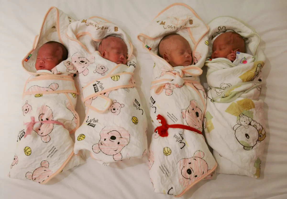 One-month-old quadruplets are ready to leave the Tongji Hospital and go home in Wuhan, Hubei Province, China, on July 27, 2007. (China Photos/Getty Images)