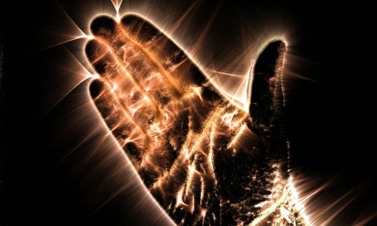 Kirlian aura photography shows a glowing human hand. (Shutterstock/ MP_Foto)