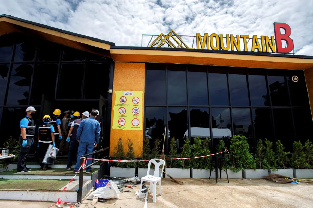 Forensic officers enter the Mountain B nightclub where at least 13 people were killed and 35 injured when a fire broke out early on Friday, in Chonburi Province, Thailand, on Aug. 5, 2022. (Tanat Chayaphattharitthee/Reuters)