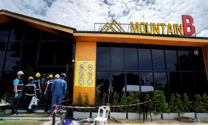 Forensic officers enter the Mountain B nightclub where at least 13 people were killed and 35 injured when a fire broke out early on Friday, in Chonburi Province, Thailand, on Aug. 5, 2022. (Tanat Chayaphattharitthee/Reuters)