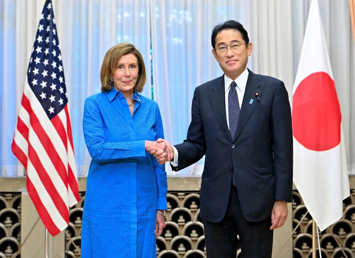 US House Speaker Nancy Pelosi (L) shakes hands with Japanese Prime Minister Fumio Kishida during a meeting at the prime minister's official residence in Tokyo on Aug. 5, 2022. (Japan Pool/Jiji Press/AFP via Getty Images)