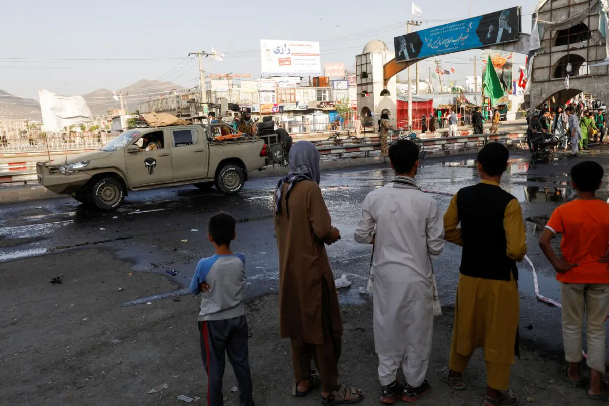 Taliban extremists  stand guard at the site of a blast in Kabul, Afghanistan, on Aug. 6, 2022. (Ali Khara/Reuters)