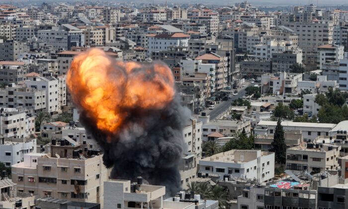 Flame and smoke rise during an Israeli air strike in Gaza City on Aug. 6, 2022. (Mohammed Salem/Reuters)