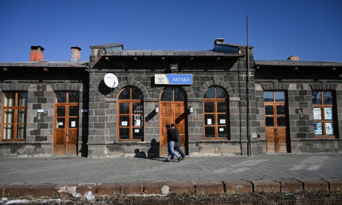 Two men walk in front of Akyaka train station on January 9, 2022 in Akyaka district of Kars city, eastern Turkey, near the Turkish–Armenian border. (Ozan Kose/AFP via Getty Images)