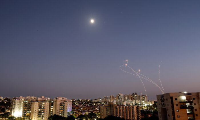 Streaks of light are seen as Israel's Iron Dome anti-missile system intercept rockets launched from the Gaza Strip toward Israel, as seen from Ashkelon, Israel, on Aug. 7, 2022. (Amir Cohen/Reuters)