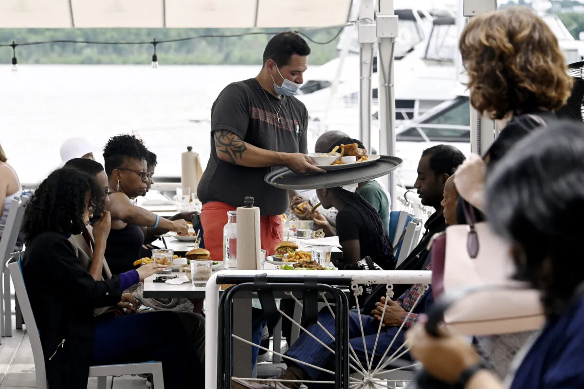 A waiter works at a restaurant in Alexandria, Va., on June 3, 2022. (OLIVIER DOULIERY/AFP via Getty Images)