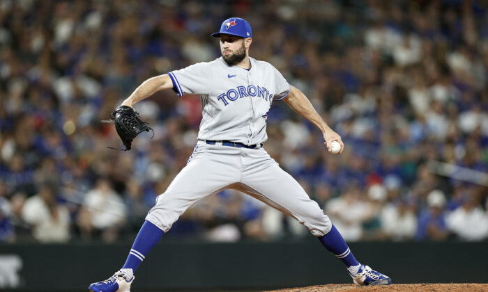 Tim Mayza (58) of the Toronto Blue Jays pitches during the eighth inning against the Seattle Mariners at T-Mobile Park in Seattle on July 8, 2022. (Steph Chambers/Getty Images)