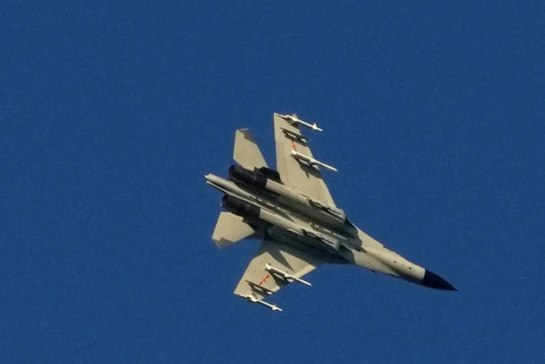 A Chinese People's Liberation Army (PLA) aircraft flies over the 68-nautical-mile scenic spot, one of mainland China's closest points to the island of Taiwan, in Pingtan island, Fujian Province, China on Aug. 5, 2022. (Aly Song/Reuters)