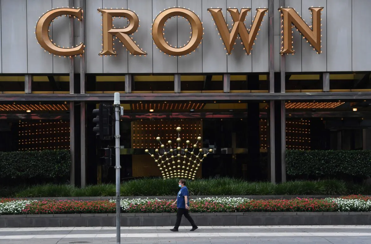 A person walks past signage at the Crown Casino in Melbourne, Australia, on March 22, 2021. (William West/AFP via Getty Images)