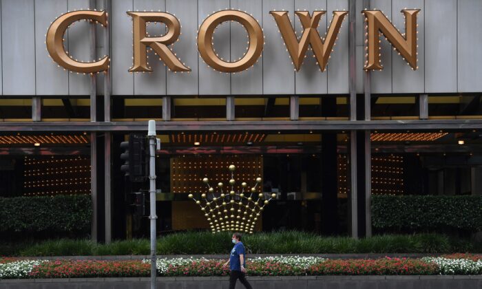 A person walks past signage at the Crown Casino in Melbourne, Australia, on March 22, 2021. (William West/AFP via Getty Images)