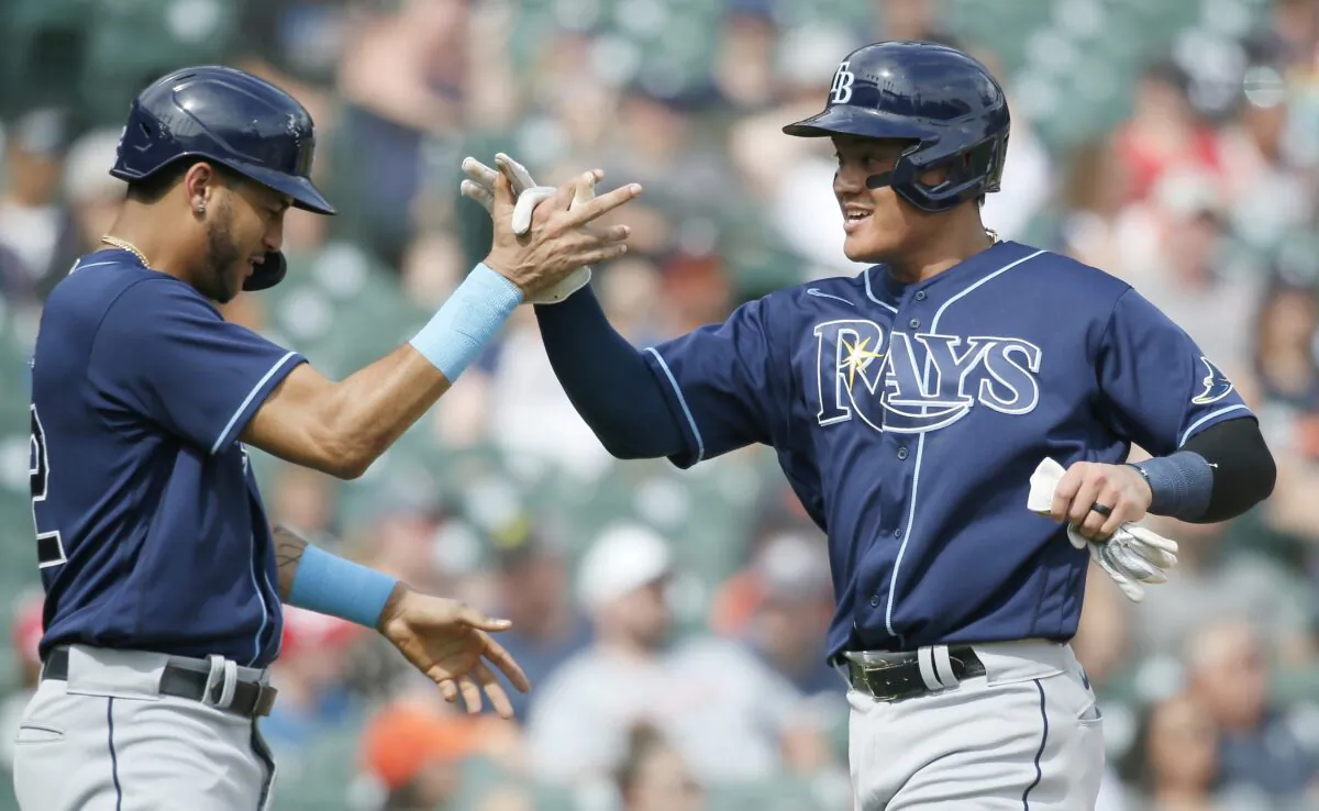 Jose Siri #22 of the Tampa Bay Rays celebrates with Yu Chang #9 after they scored against the Detroit Tigers on a single by Brandon Lowe during the ninth inning at Comerica Park in Detroit, August 7, 2022. (Duane Burleson/Getty Images)