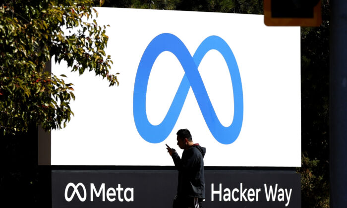 A pedestrian walks in front of a Meta sign at Facebook headquarters in Menlo Park, Calif., on Oct. 28, 2021. (Justin Sullivan/Getty Images)