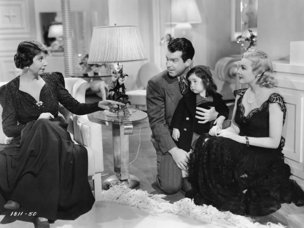 (L–R) Helen Broderick, Fred MacMurray, child actor Carolyn Lee, and Madeleine Carroll in "Honeymoon in Bali." (Paramount Pictures)