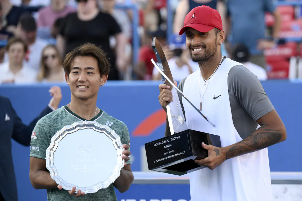 Nick Kyrgios, right, of Australia, poses with the winners trophy after he defeated Yoshihito Nishioka, left, of Japan, during a final at the Citi Open tennis tournament in Washington, Sunday, Aug. 7, 2022. (Nick Wass/AP Photo)