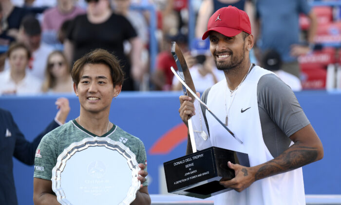 Nick Kyrgios, right, of Australia, poses with the winners trophy after he defeated Yoshihito Nishioka, left, of Japan, during a final at the Citi Open tennis tournament in Washington, Sunday, Aug. 7, 2022. (Nick Wass/AP Photo)