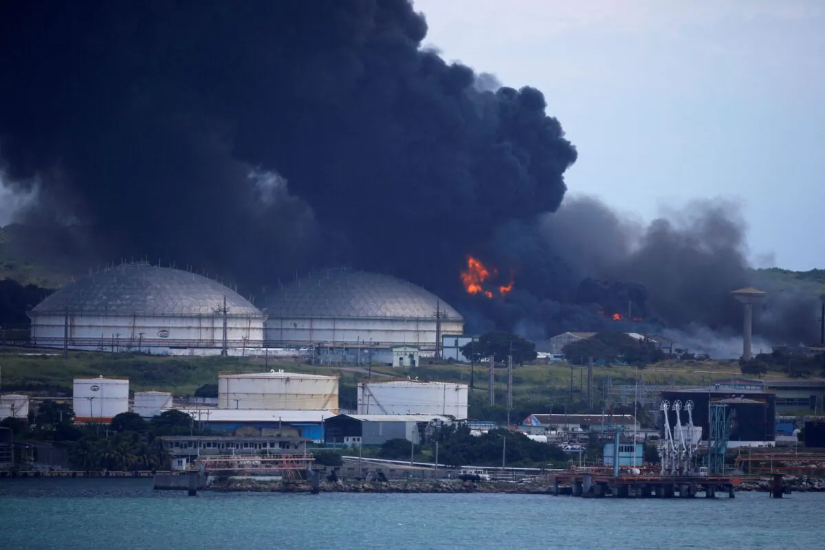 Fire over fuel storage tanks that exploded near Cuba's supertanker port in Matanzas, Cuba, on Aug. 7, 2022. (Alexandre Meneghini/Reuters)