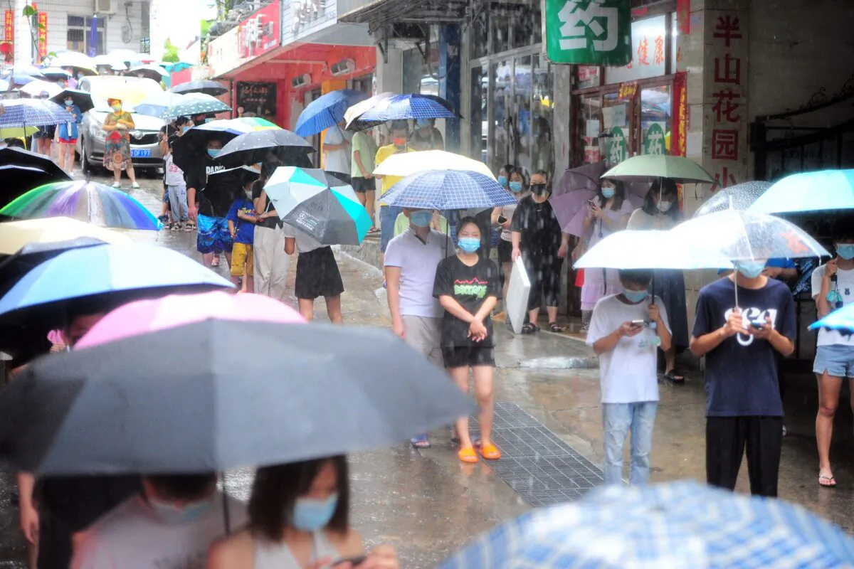 Residents and tourists line up to take COVID-19 PCR tests in Sanya in southern China's Hainan Province on Aug. 8, 2022. (STR/AFP via Getty Images)