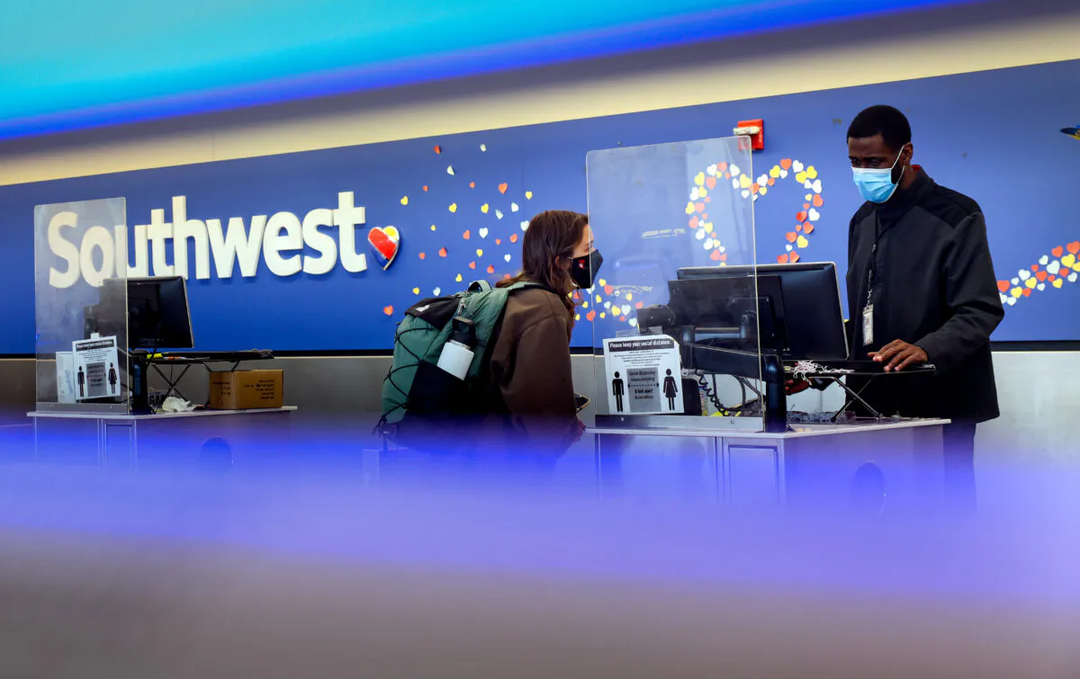 A traveler checks in at the Southwest Airlines ticketing counter at Baltimore Washington International Thurgood Marshall Airport in Baltimore, Md., on Oct. 11, 2021. (Kevin Dietsch/Getty Images)