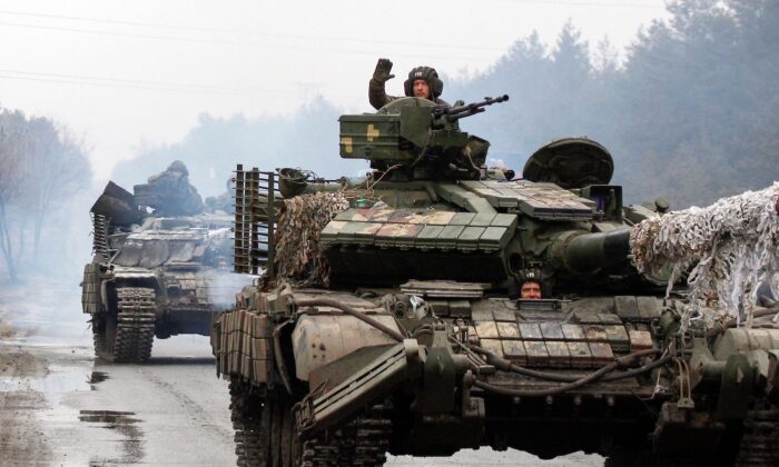 Ukrainian servicemen ride on tanks toward the front line with Russian forces in the Lugansk region of Ukraine, on Feb. 25, 2022. (Anatolii Stepanov/AFP via Getty Images)