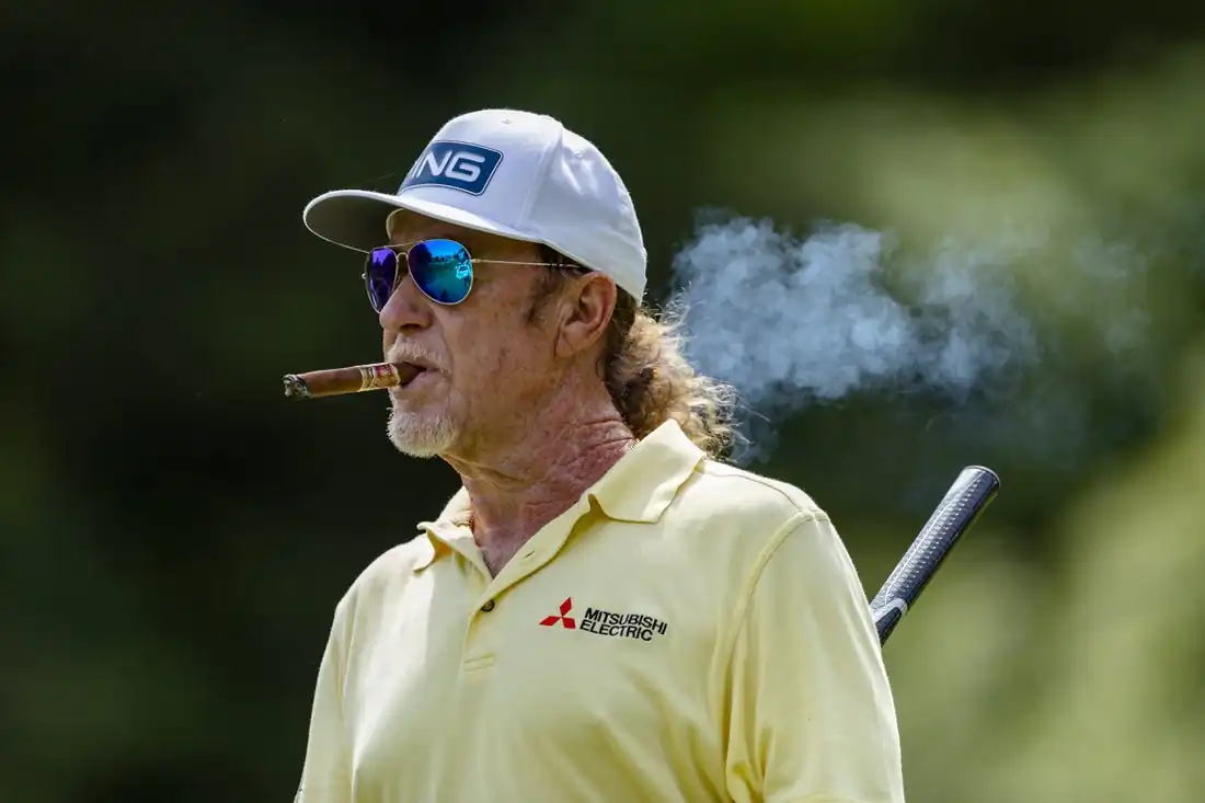 Miguel Angel Jimenez walks off the tee box while smoking a cigar on the thirteenth hole during the final round of the 2022 KitchenAid Senior PGA Championship at Harbor Shores, Benton Harbor, Mich.,    May 29, 2022. (Raj Mehta/USA TODAY Sports via Field Level Media)