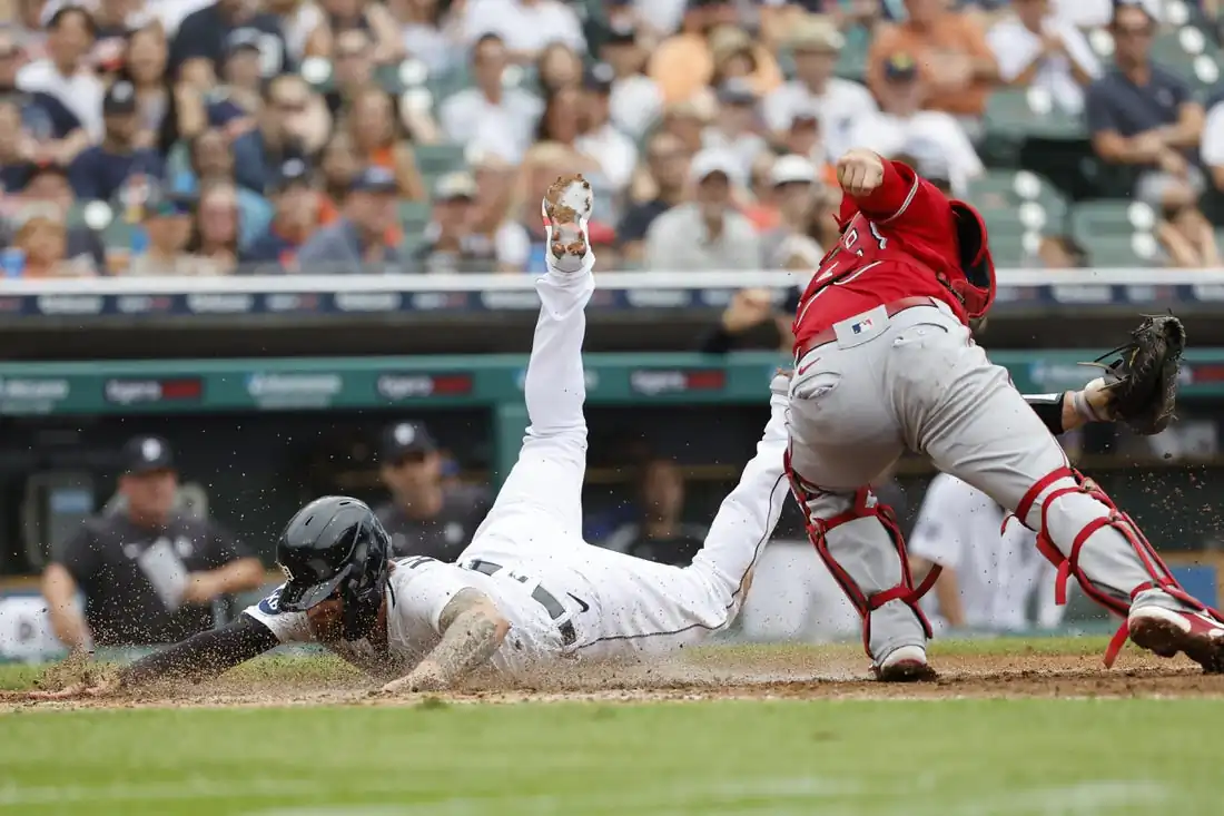 Detroit Tigers designated hitter Eric Haase (13) dives in safe at home ahead of the tag by Los Angeles Angels catcher Max Stassi (33) in the third inning at Comerica Park in Detroit, Aug 20, 2022. (Rick Osentoski/USA TODAY Sports via Field Level Media)