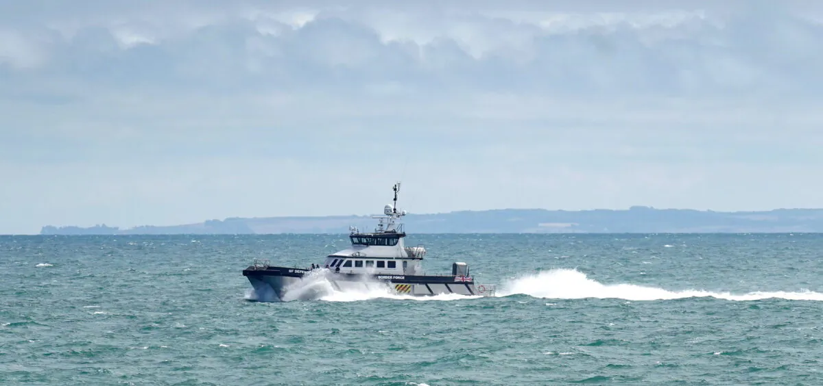 Border Force vessel Defender carries a group of people thought to be migrants in to Dover, Kent, following a small boat incident in the Channel, on Aug. 23, 2022. (Gareth Fuller/PA)