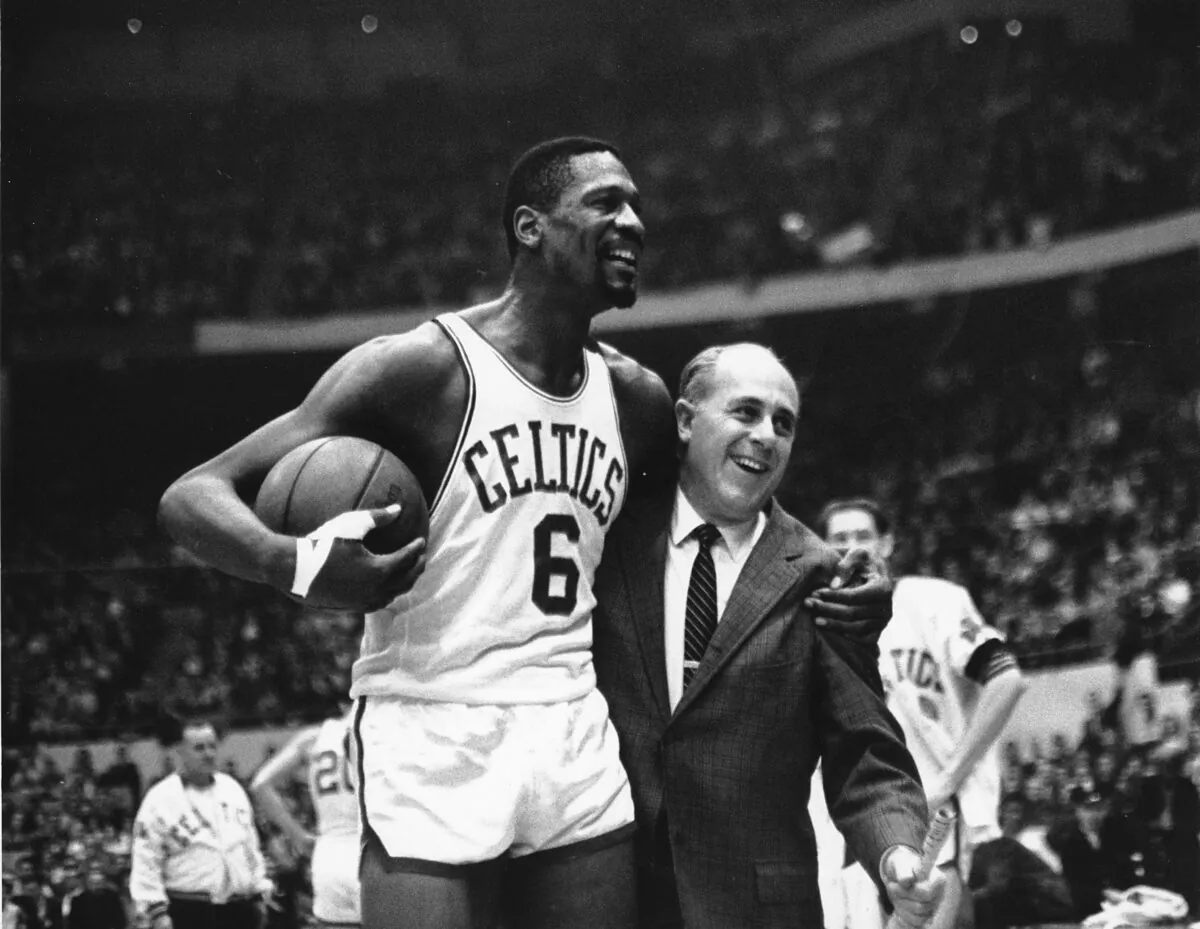 Bill Russell, left, star of the Boston Celtics is congratulated by coach Arnold "Red" Auerbach after scoring his 10,000th point in the NBA game against the Baltimore Bullets at Boston Garden in Boston, on Dec. 12, 1964. (Bill Chaplis/AP Photo)