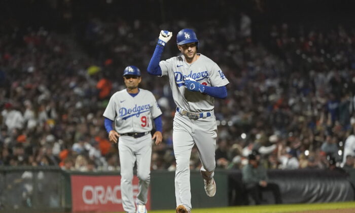 Los Angeles Dodgers' Trea Turner gestures in front of third base coach Dino Ebel (91) after hitting a home run against the San Francisco Giants during the seventh inning of a baseball game in San Francisco, Monday, Aug. 1, 2022. (Jeff Chiu/AP Photo)